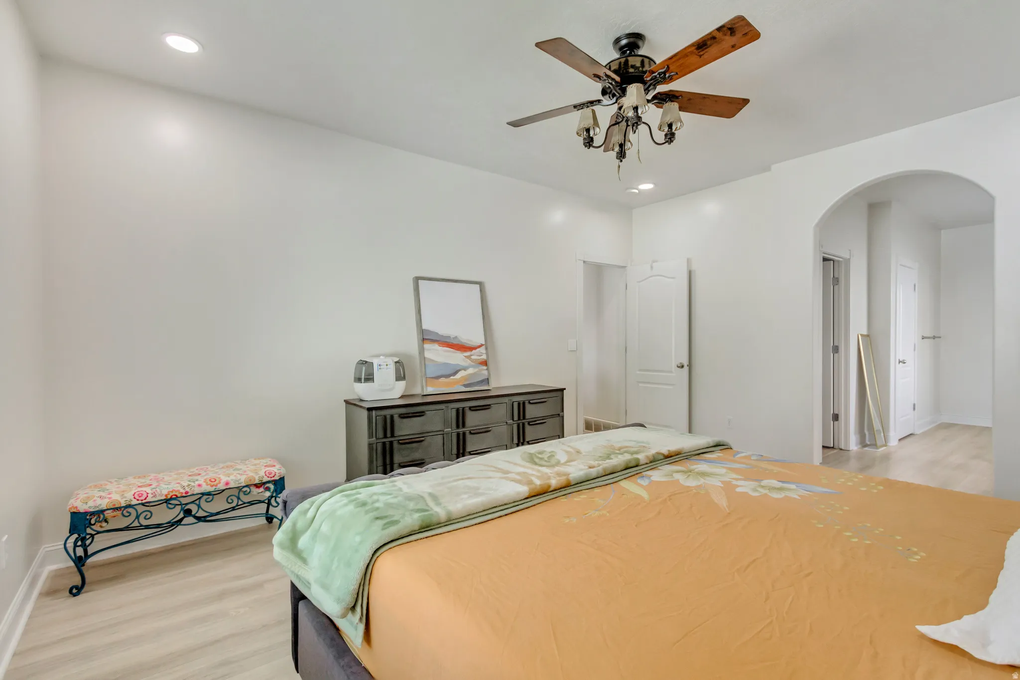 Expansive room featuring wood-finish flooring, recessed lighting, and a ceiling fan with light fixture