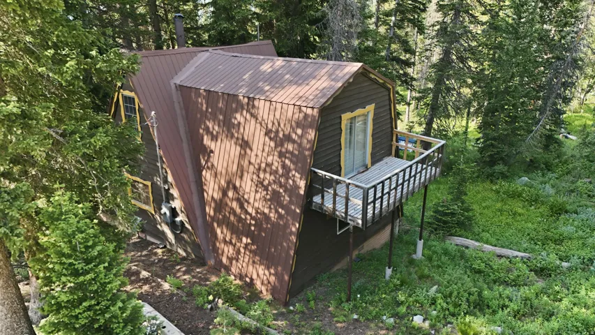 Wood-sided property featuring a brown metal roof