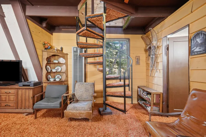 Black spiral staircase with carpeted treads