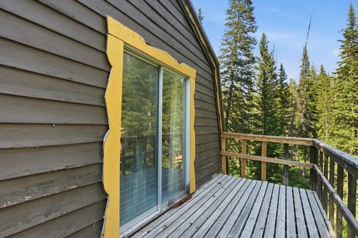 Outdoor deck featuring natural wood railing and wood-plank flooring