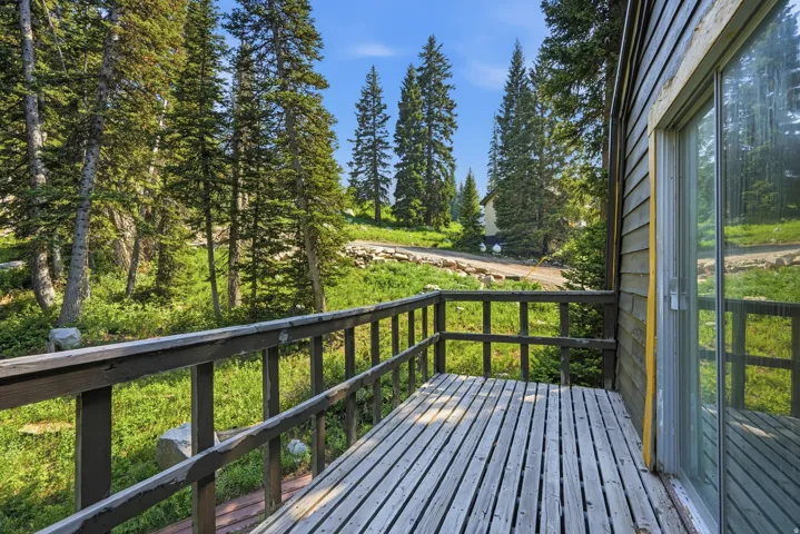 Private wooden deck with slatted flooring and matching railings