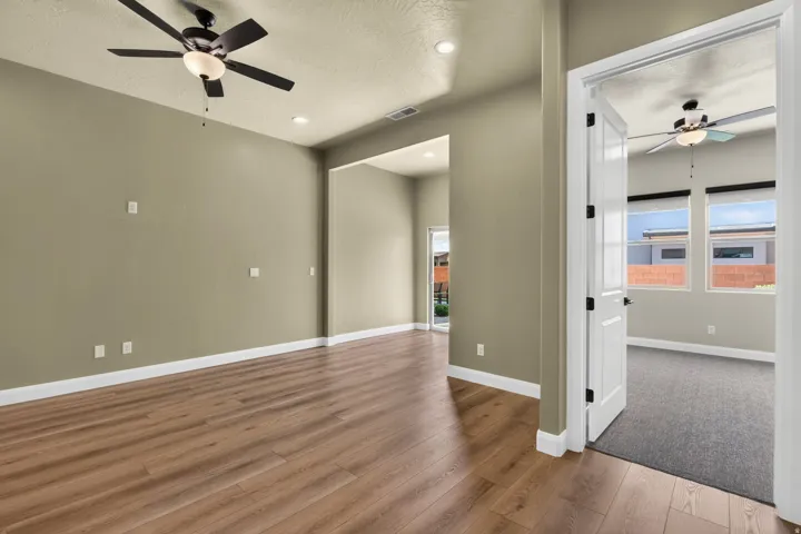 Spacious interior with wood-finish flooring, recessed lighting, and a ceiling fan