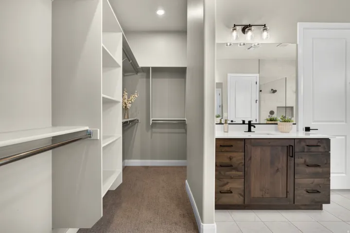 Spacious walk-in closet with extensive built-in shelving and hanging rods