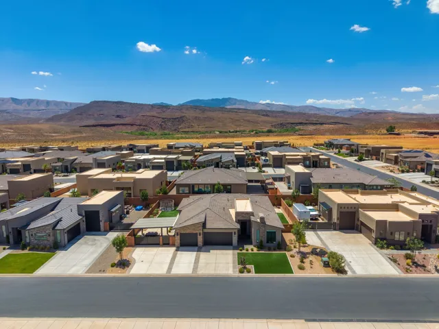 Modern desert community featuring a stucco and stone-clad residence with a two-car garage