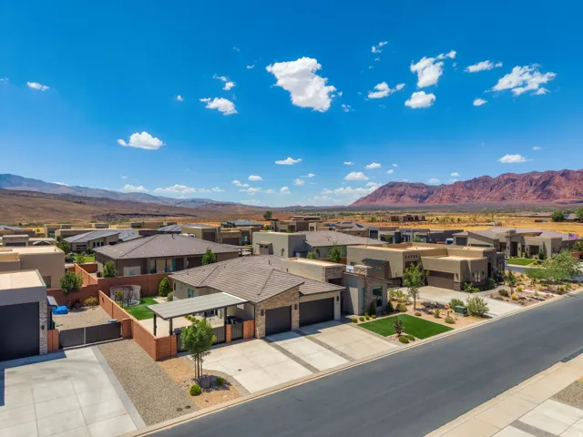 Expansive residential development featuring contemporary architecture with flat and low-slope roofs, integrated garages, and desert-adapted landscaping