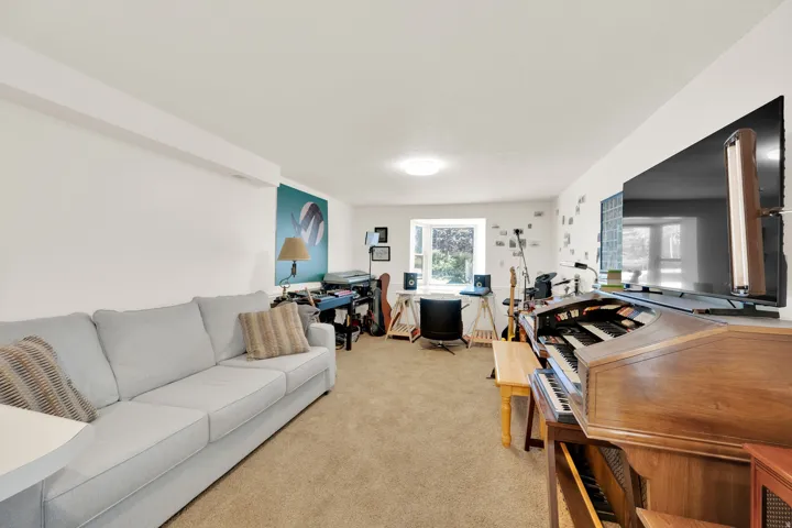 Carpeted room with white walls, a recessed window, and a flush-mount ceiling light