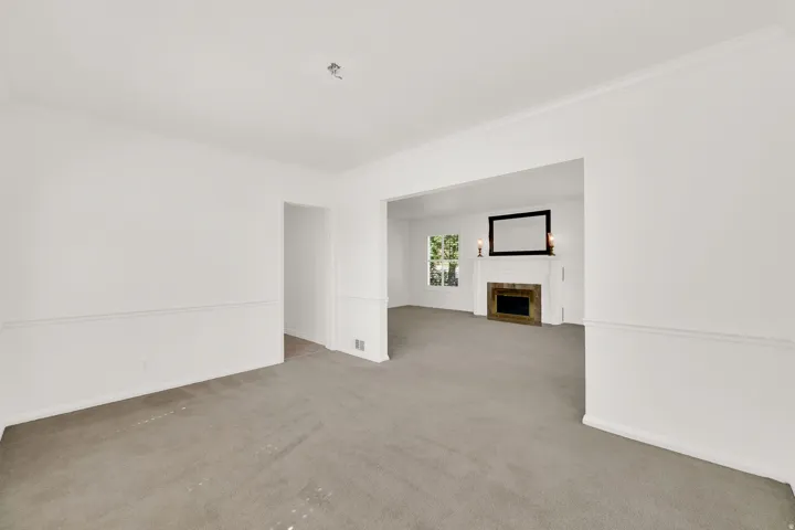Spacious interior featuring neutral carpeting and white wall finishes