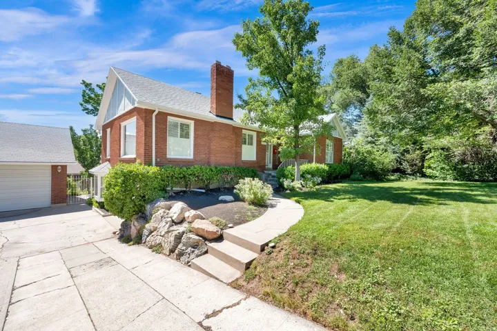 Brick exterior residence with a side-gabled roof and prominent chimney