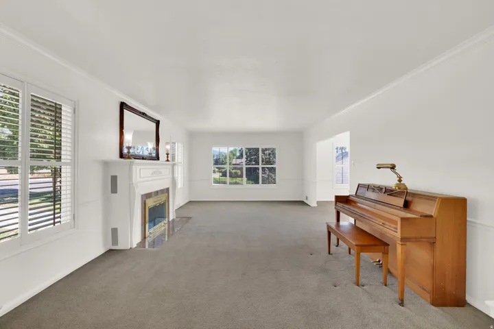 Spacious interior featuring white walls and crown molding