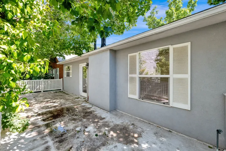 Concrete patio area featuring a textured stucco exterior