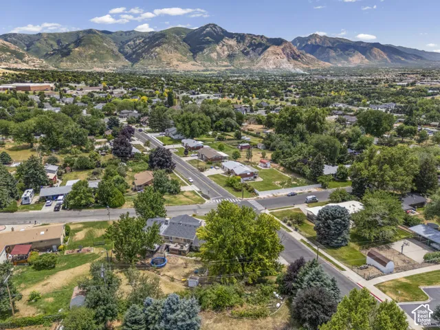 Panoramic mountain backdrop featuring a developed residential area with mature trees and established homes