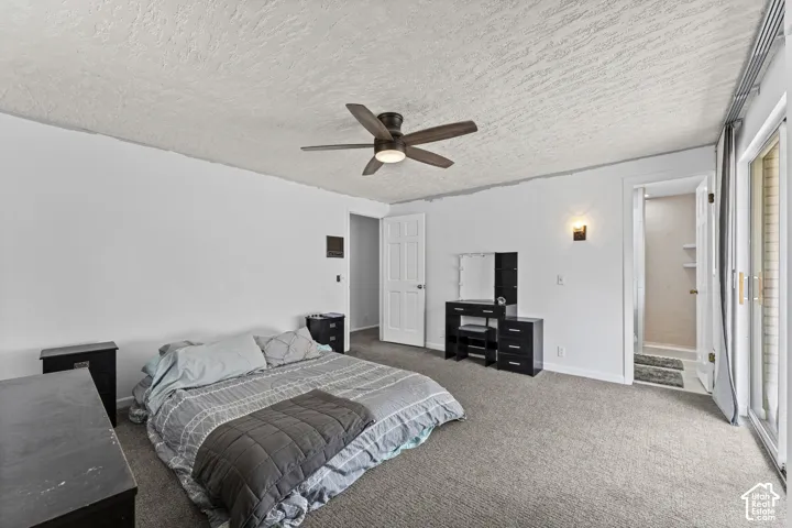Bedroom featuring neutral carpeting, a ceiling fan, and white walls