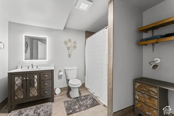 Bathroom featuring a dark wood-finish vanity with a white countertop and rectangular undermount sink