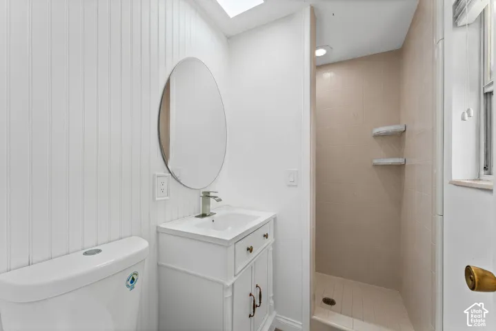 Contemporary bathroom featuring a white vanity with a rectangular sink, brushed nickel faucet, and an oval mirror