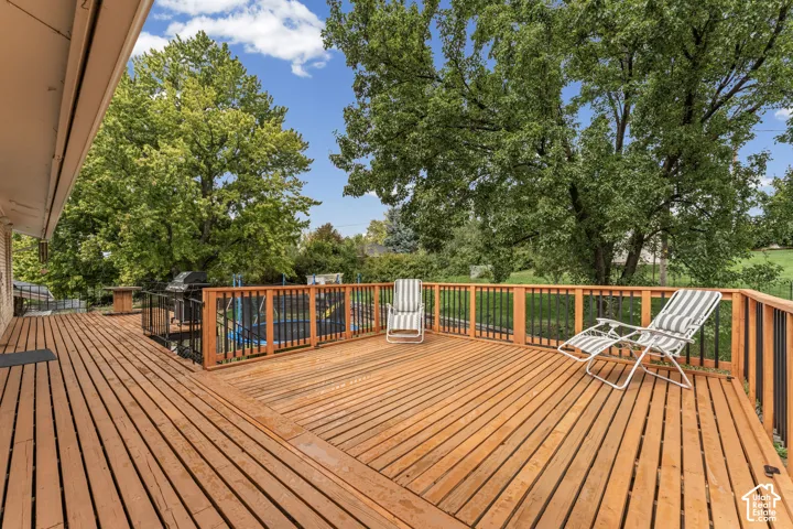 Expansive wood-finish deck with a wood and metal railing system