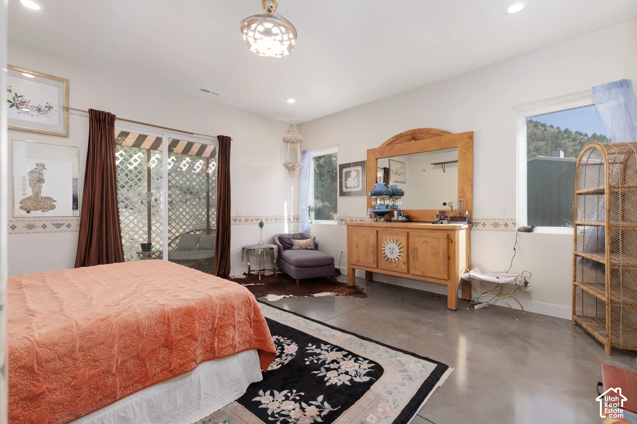 Spacious room featuring concrete flooring and white walls