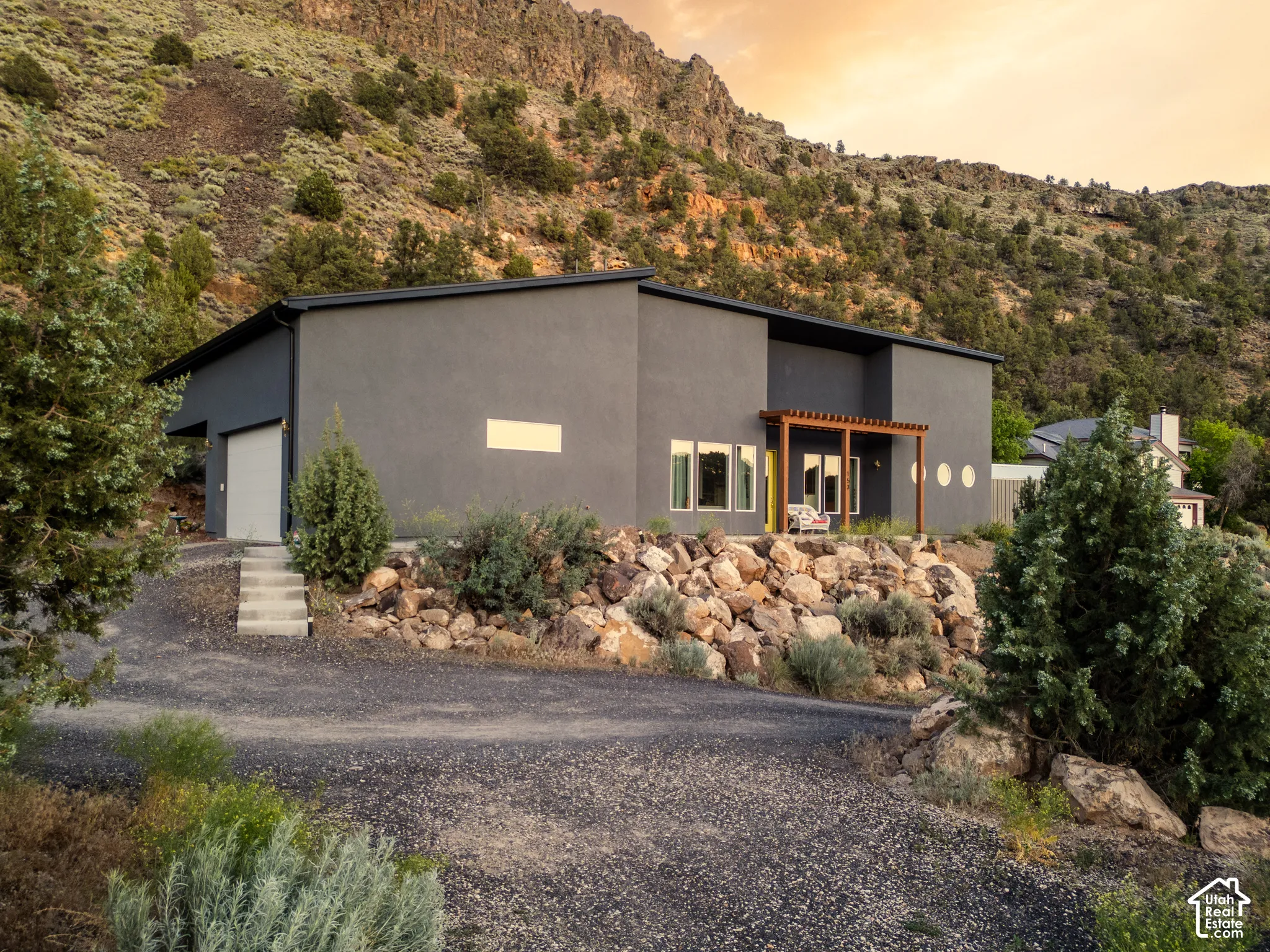 Modern architecture featuring a dark gray stucco exterior and a flat roofline