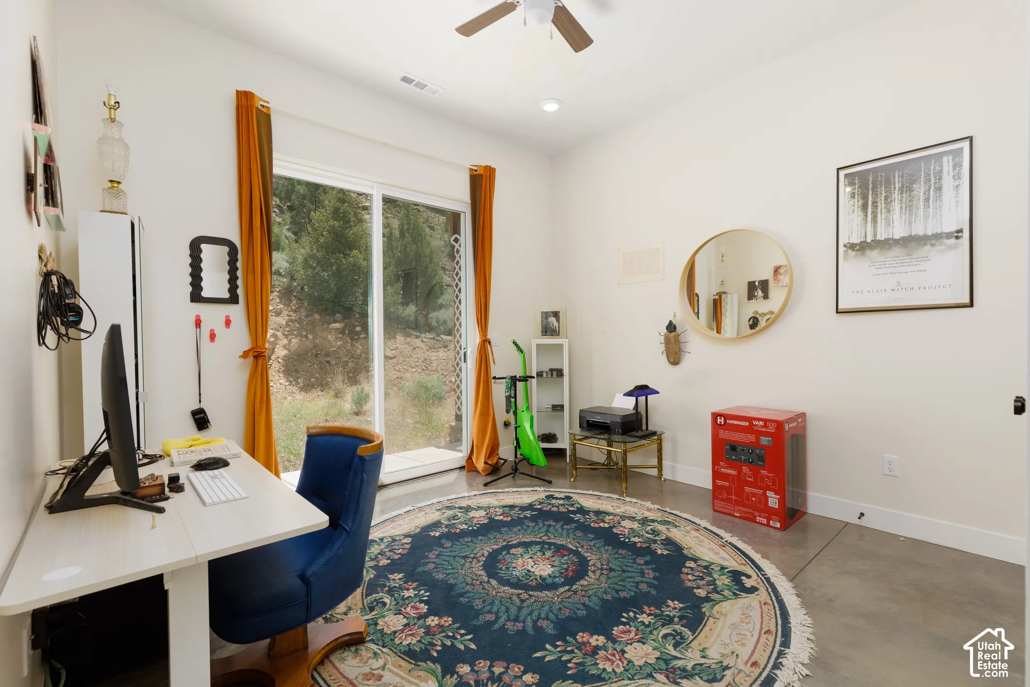 Room featuring white walls and a large sliding glass door, providing ample natural light