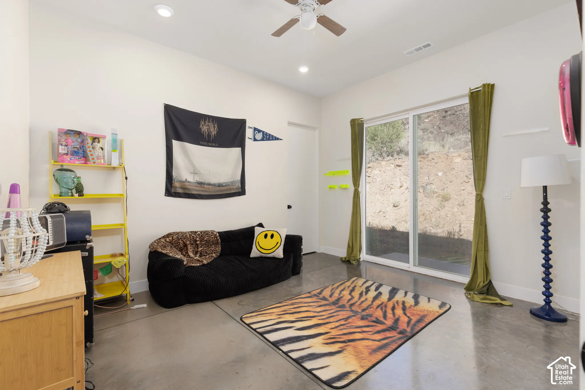 Living area featuring a sliding glass door, recessed lighting, and a ceiling fan