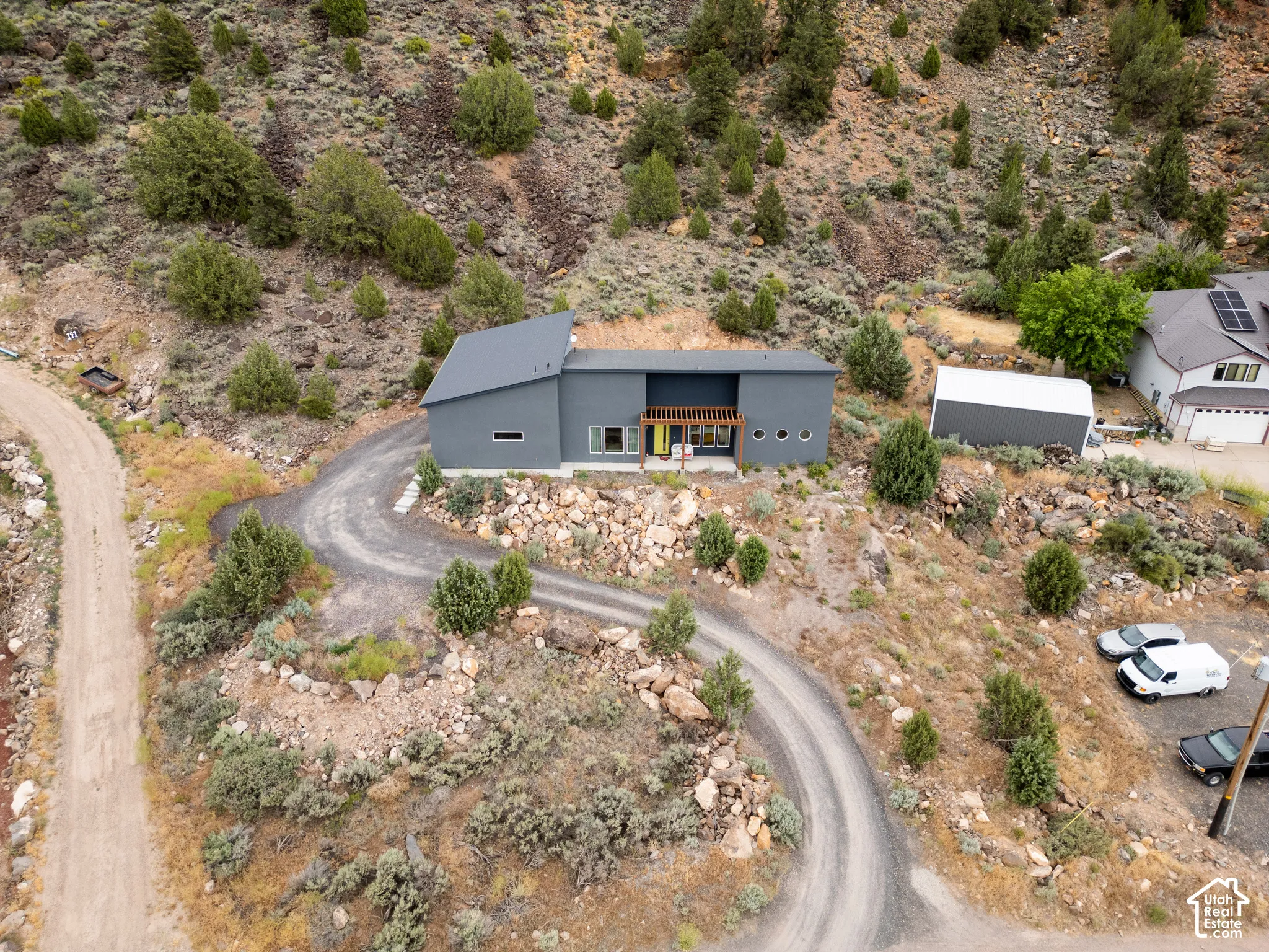 Modern-style residence with a dark gray exterior and an asymmetrical roofline