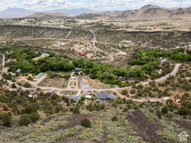 Expansive aerial perspective showcasing a rural landscape with winding roads and scattered residential properties