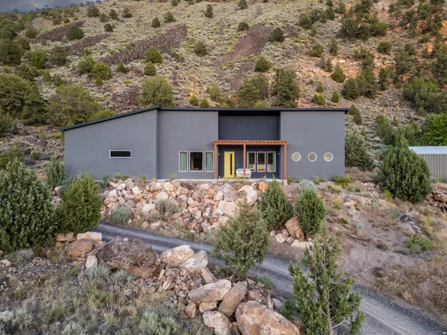 Contemporary residence featuring a flat roofline and grey stucco exterior