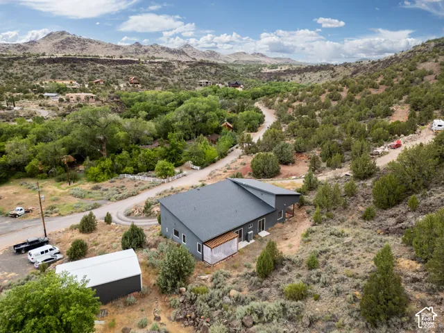Contemporary single-story residence with a dark gray exterior and a complementary dark gray roof