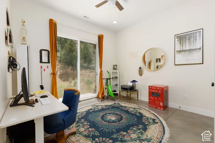 Room featuring white walls and a large sliding glass door, providing ample natural light