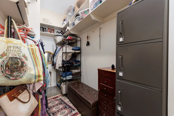 White shelving units, hanging rods, and built-in storage solutions