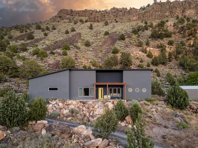 Modern dwelling with a flat roofline and dark gray exterior