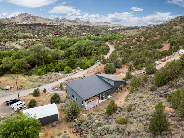 Contemporary single-story residence with a dark gray exterior and a complementary dark gray roof