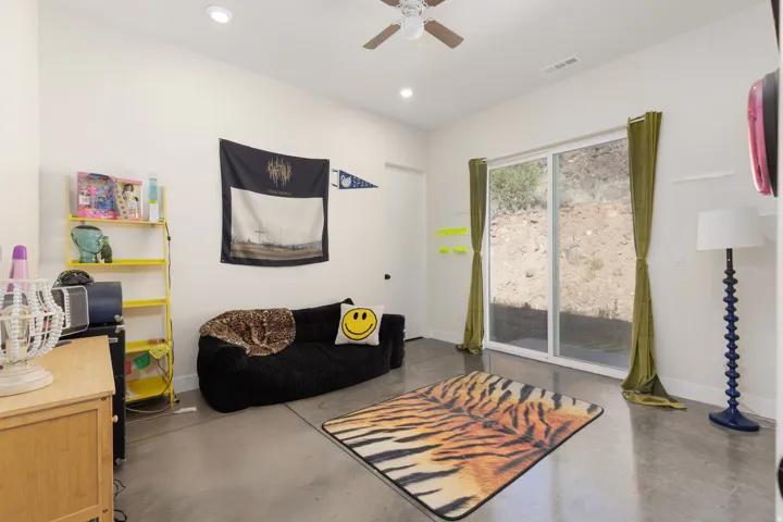 Living area featuring a sliding glass door, recessed lighting, and a ceiling fan