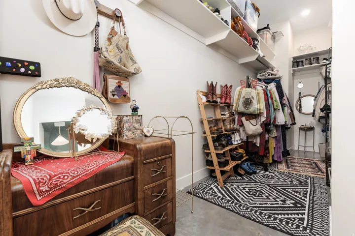 Custom closet organization system featuring white shelving and a vanity area