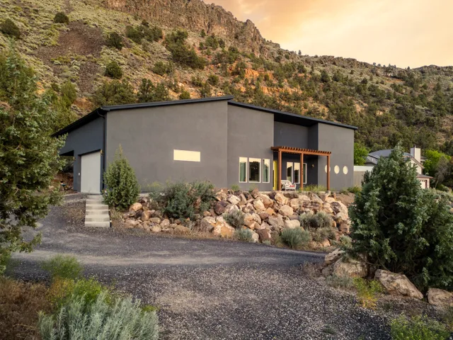 Modern architecture featuring a dark gray stucco exterior and a flat roofline