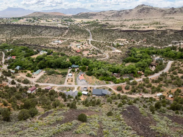 Expansive aerial perspective showcasing a rural landscape with winding roads and scattered residential properties