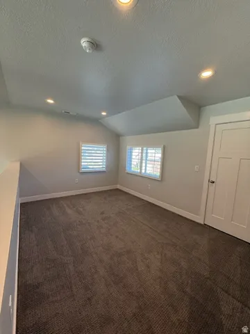 Bright secondary bedroom featuring recessed ceiling lighting, dual windows with plantation shutters, and neutral wall finishes