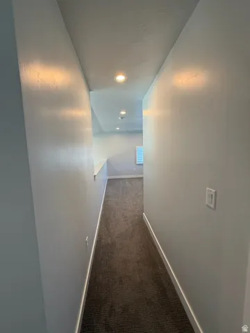 Recessed ceiling lighting, textured ceiling finish, carpeted flooring, and white trim