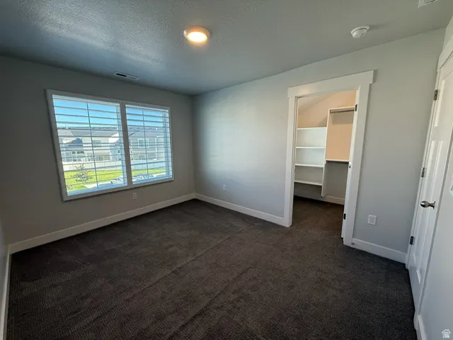 Plush carpeting, bright overhead lighting, and white trim throughout
