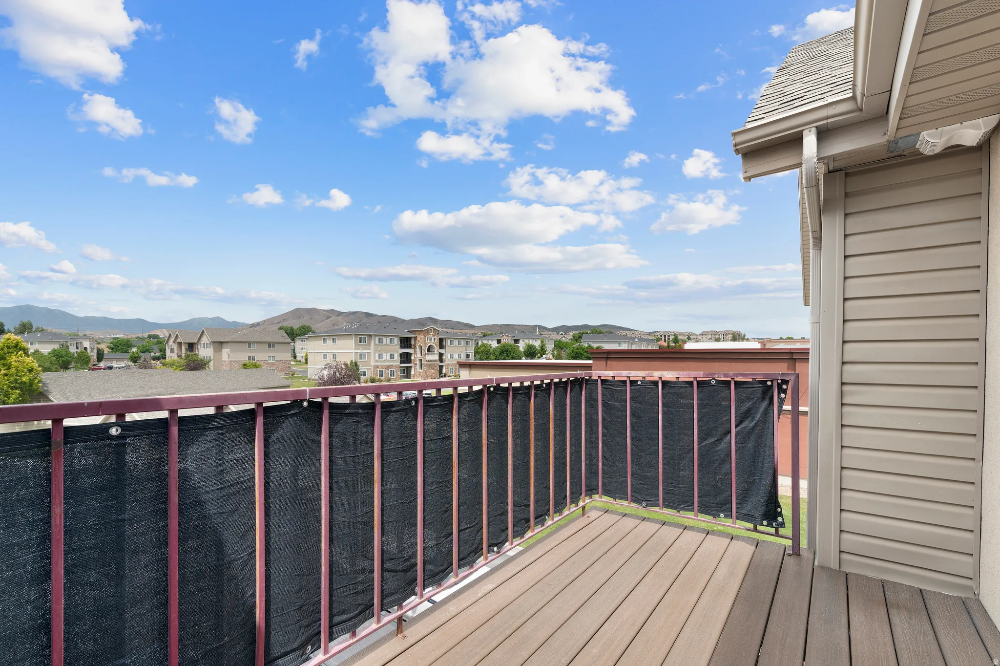 Private balcony with durable composite decking and a metal railing