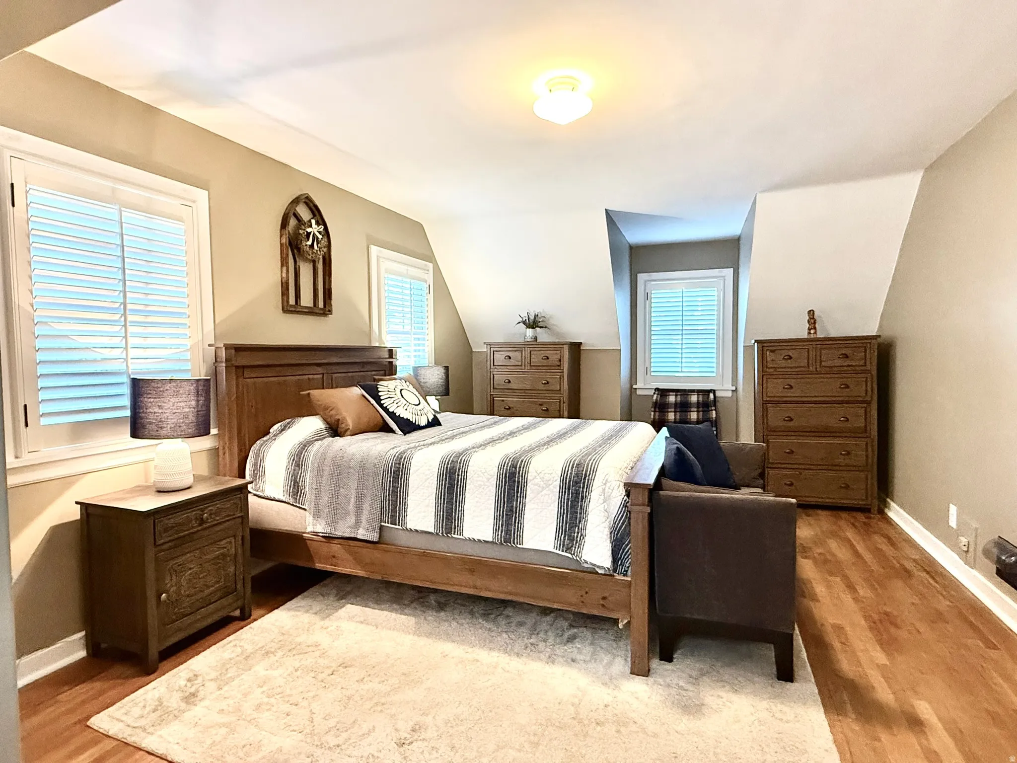 Primary Bedroom Spacious bedroom with rich wood-finish flooring