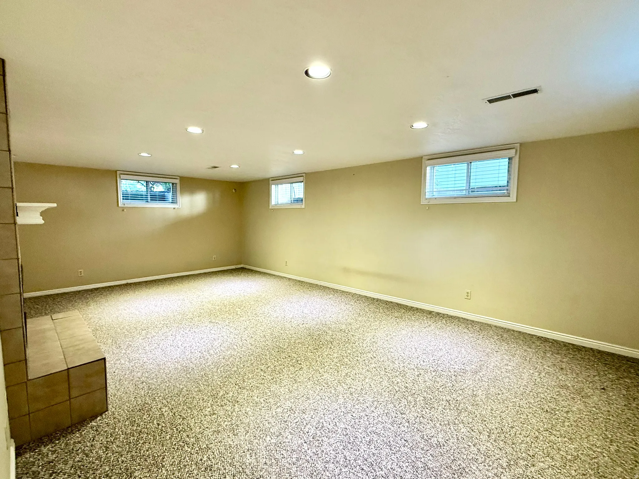 LL TV Room, Play Room or an Extra Guest Bedroom with it's own bathroom  fireplace with mantel, recessed lighting, and a window