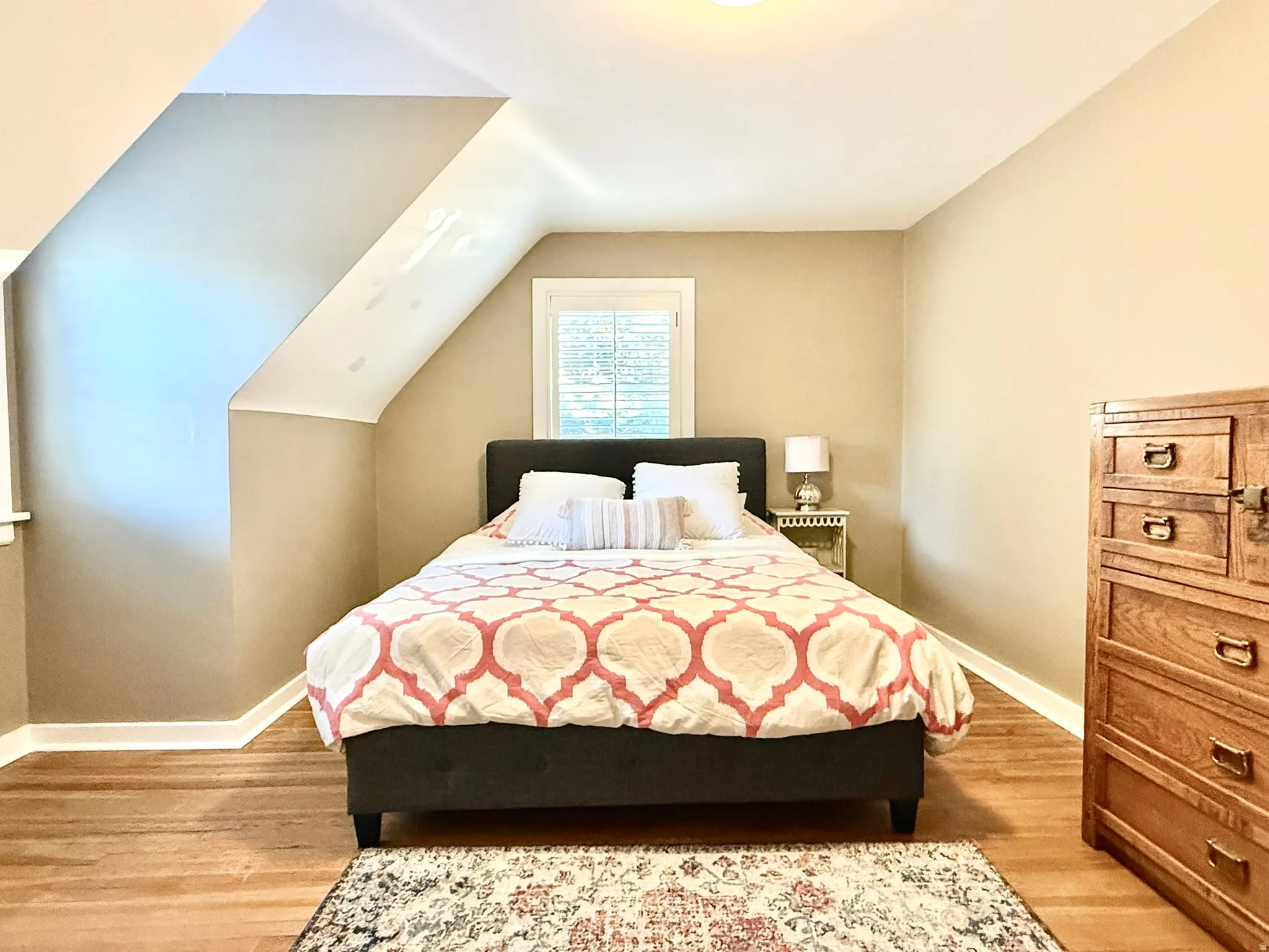 Bedroom #2  featuring sloped ceilings, a window with horizontal blinds, wood-finish flooring, and light-toned wall paint