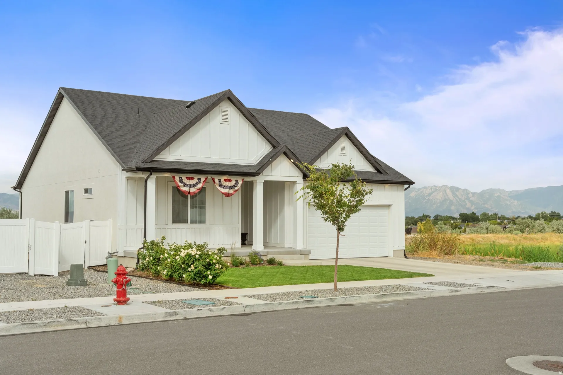Contemporary white exterior with dark roofline and board and batten accents