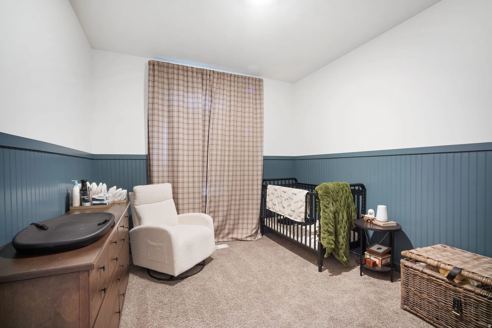 Bedroom featuring a two-tone wall treatment with a beadboard wainscoting and smooth upper wall