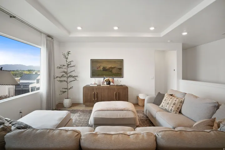 Expansive window framing distant mountains and residential rooftops