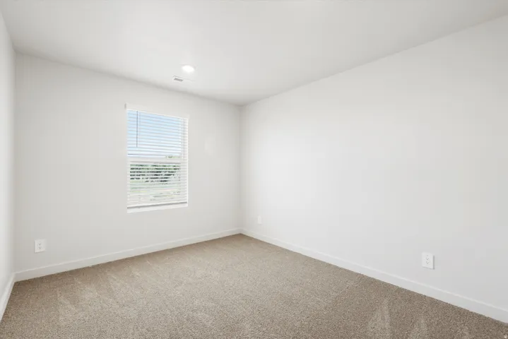 **DISCLAIMER** Interior package may vary. Neutral toned interior featuring light-colored walls, recessed ceiling lighting, and soft carpet flooring
