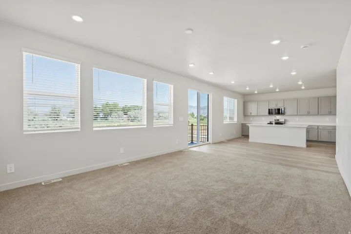 **DISCLAIMER** Interior package may vary. Open-concept interior featuring light gray walls and recessed lighting