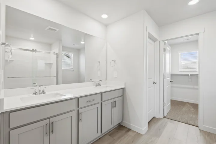 **DISCLAIMER** Interior package may vary. Dual vanity with light gray cabinetry and white countertops