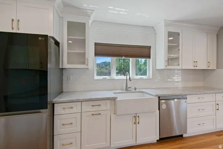 Farmhouse style sink with newer refrigerator and dishwasher
