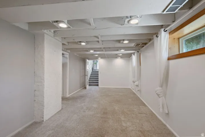 Spacious family room featuring freshly cleaned  carpet, fresh paint , recessed lighting, and new  windows